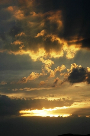 Bright sunset beneath layered clouds